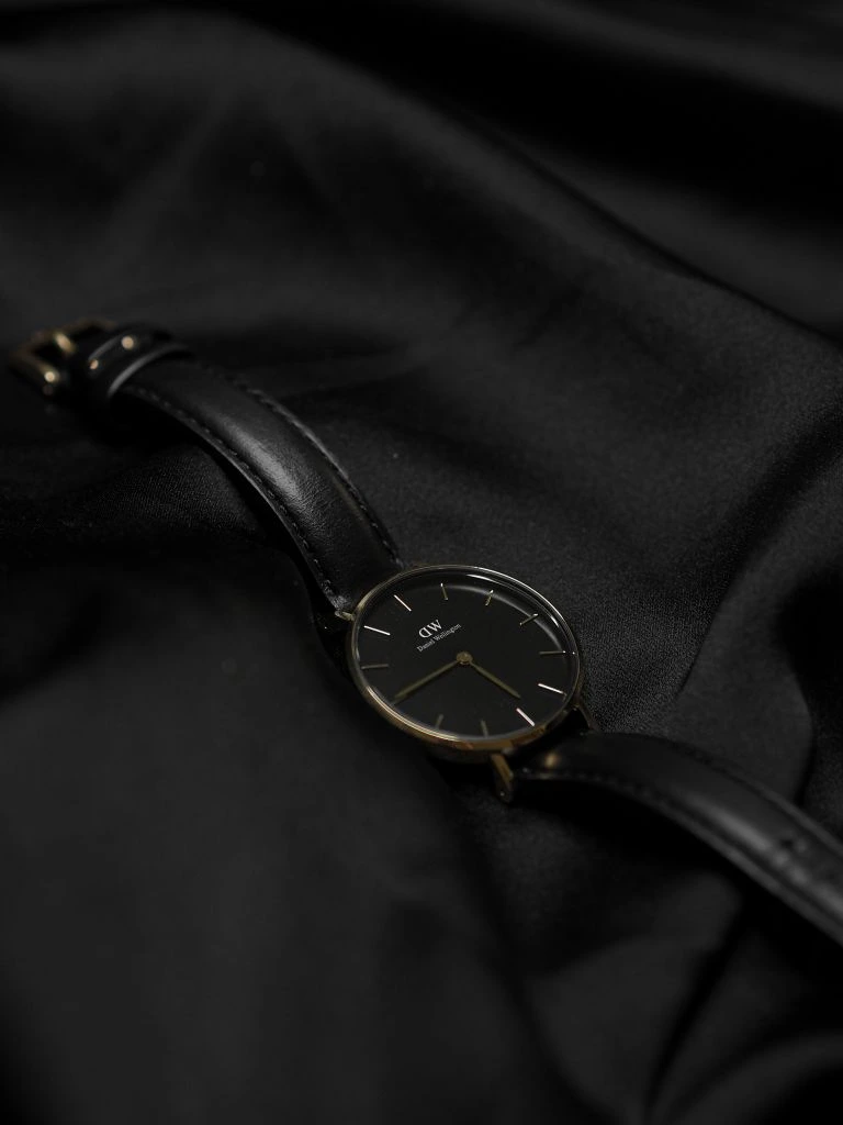 Exploded photoreal render of a luxury wristwatch under multi-color studio lighting