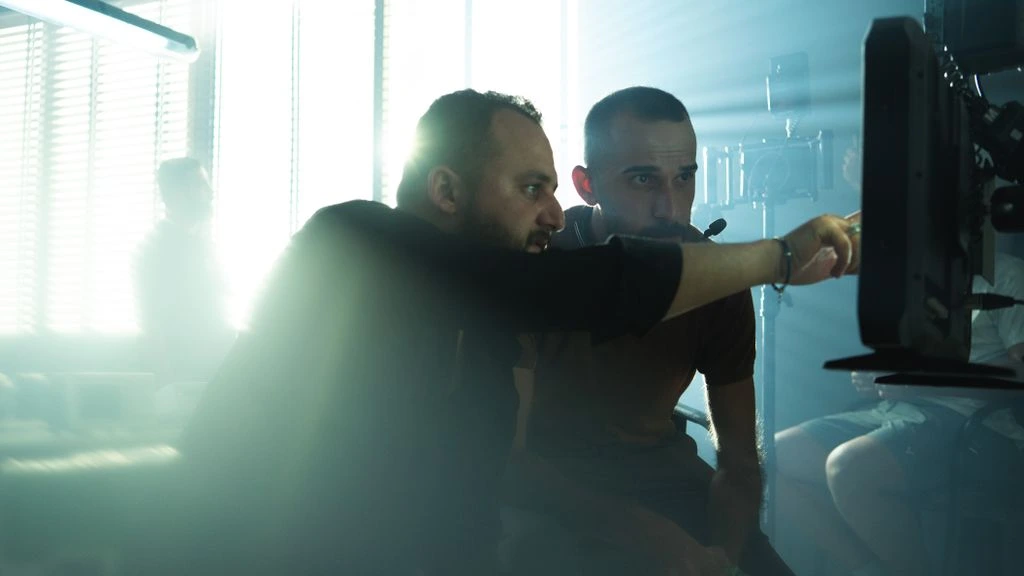 Behind-the-scenes view of a CGI launch film monitor showing a sneaker mid-explosion